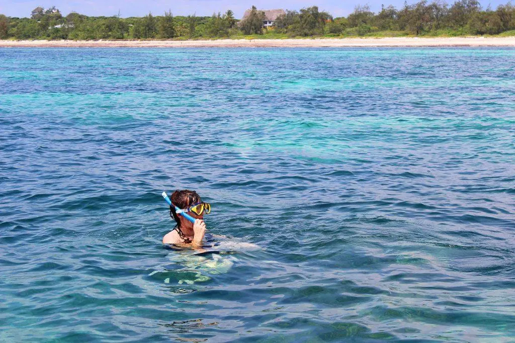 Visitor snorkeling in shallow waters at Watamu sandbank